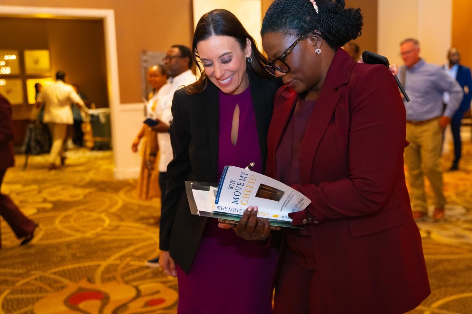 Dr. Laide Alexander signing a book for an attendee